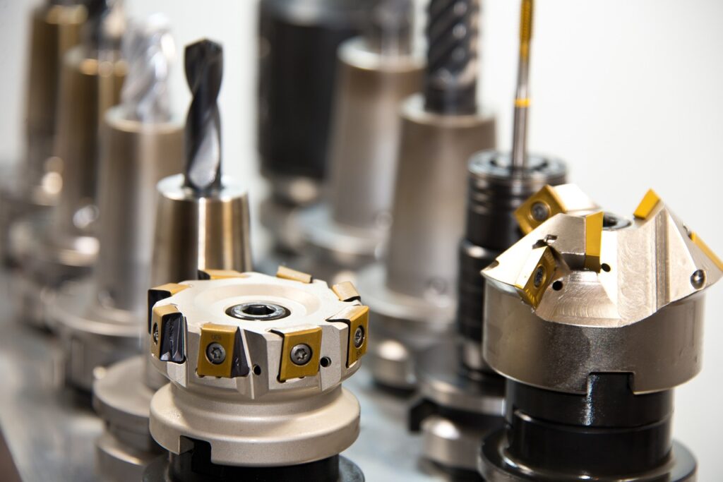 A picture of face mills, drill bits, end mills in tool holders for a cnc mill in which toolmakers would use in a tool and die shop. 