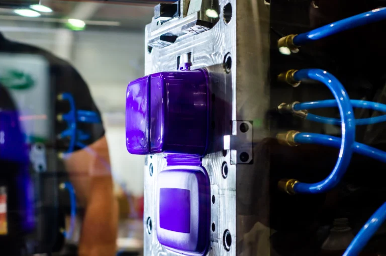 picture of purple molded part on a core of an injection mold at a product development testing site.