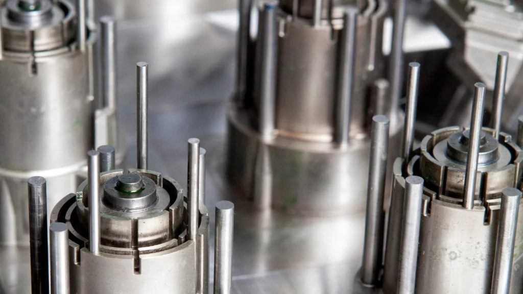 a picture of cores from an injection mold along with ejector pins protruding from the cores.