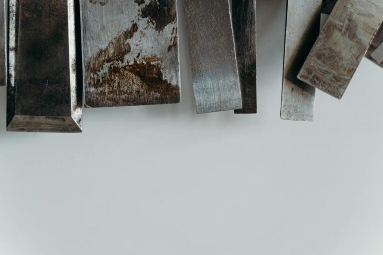 Textured tool steel pieces on a clean surface — illustrating mold steel quality comparison.