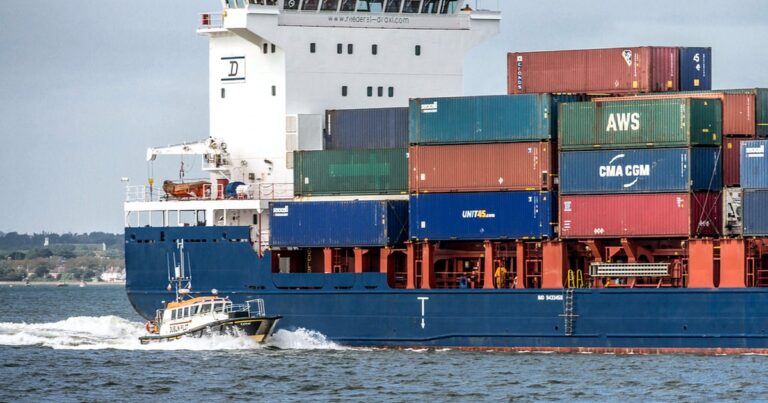 Container ship loaded with shipping containers at sea illustrating transshipment trade routes